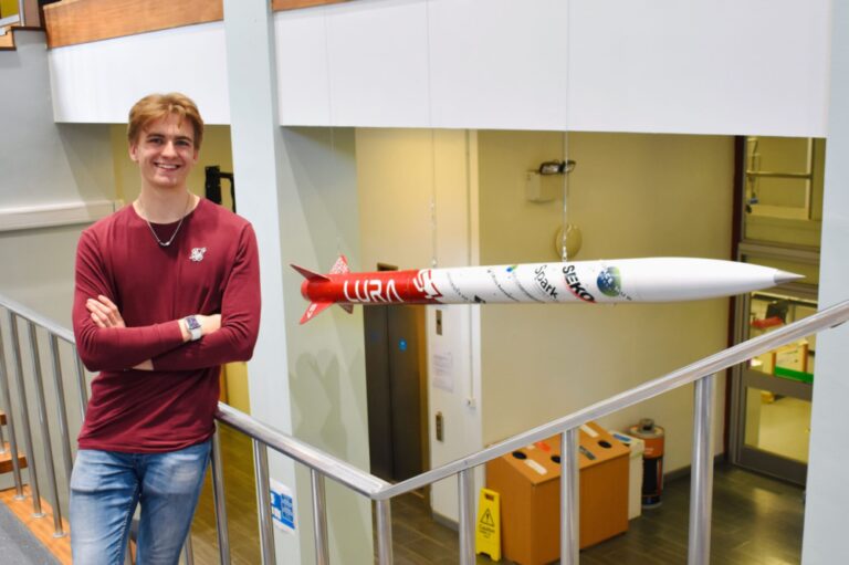 LURA director Theo Youds standing by the Gryphon I rocket in the Mecheng foyer